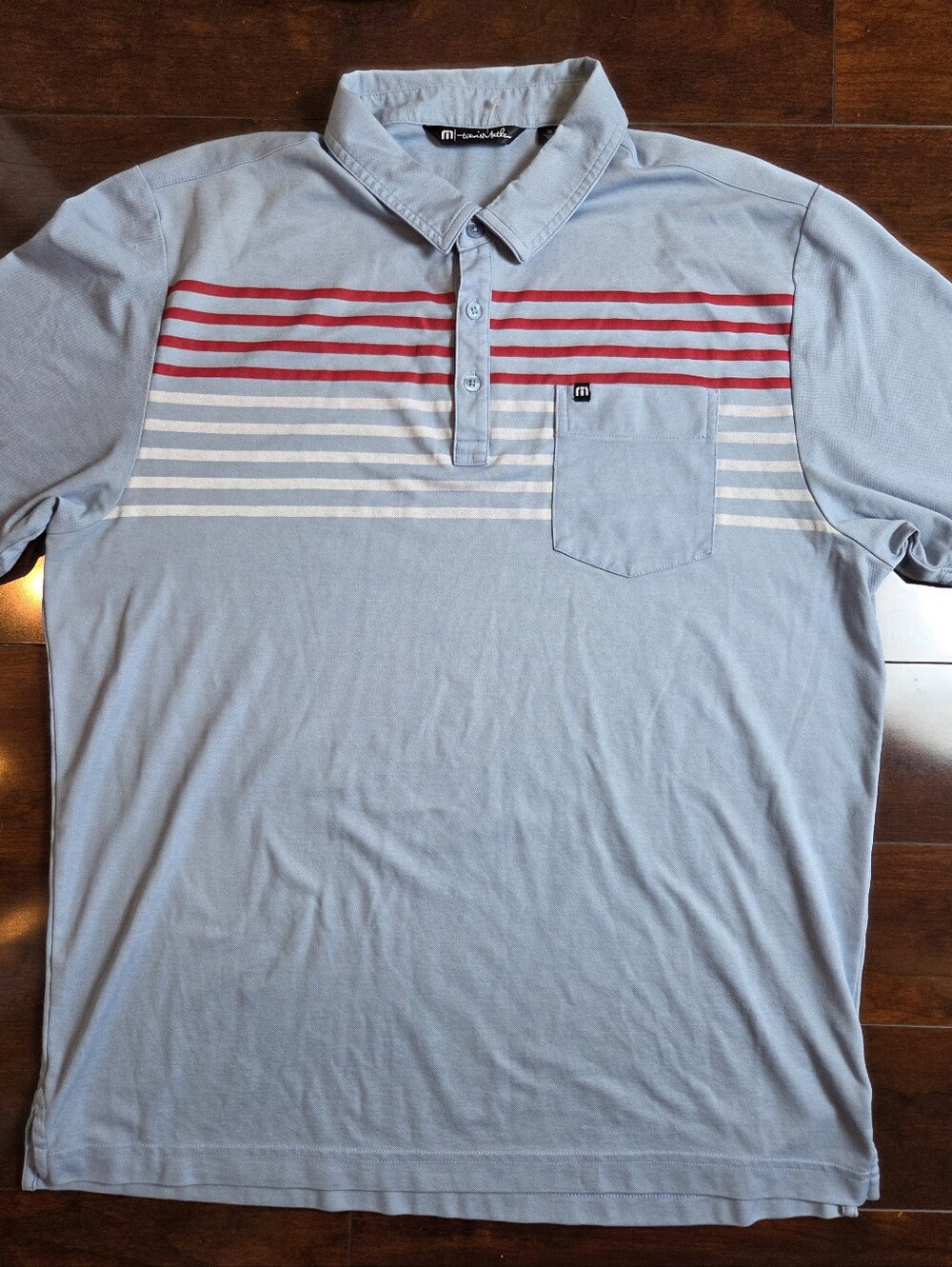 Travis Mathew Light Blue Polo with Red and White Chest Stripes